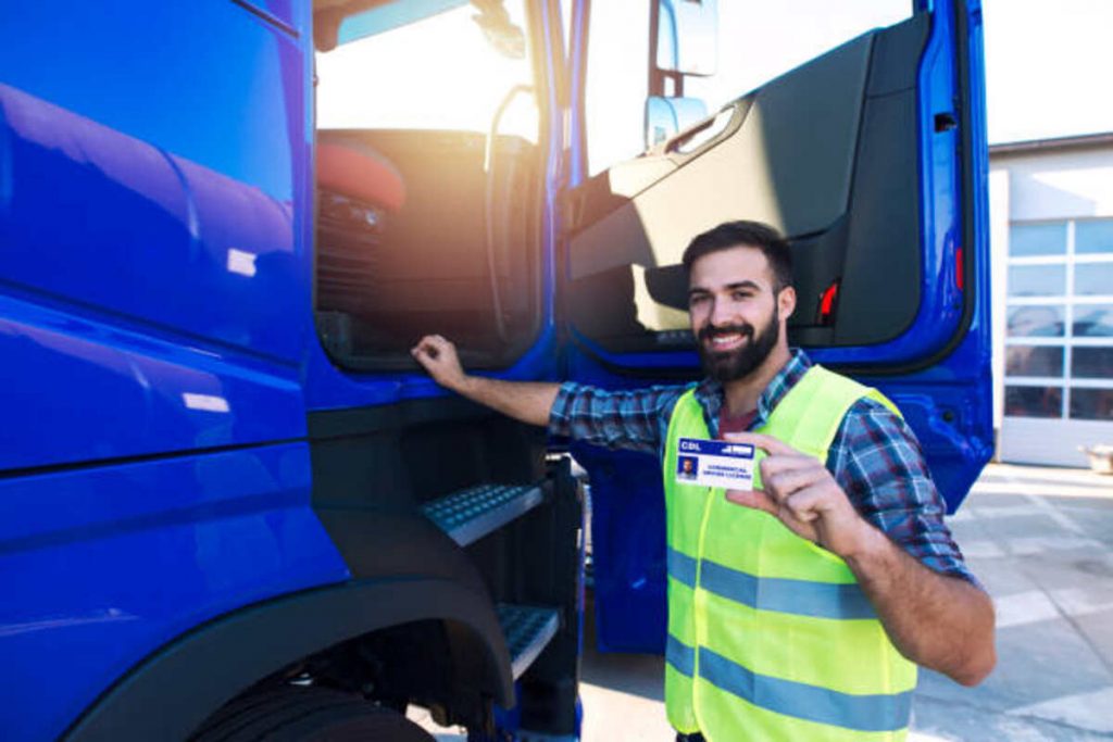 truck driver candidate showing cdl driving license successfully passed training driving exam
