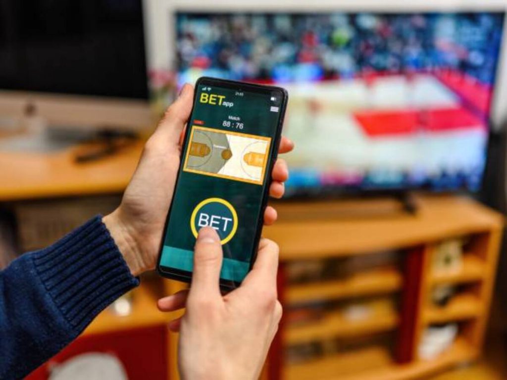 young men using smart phone for sports betting